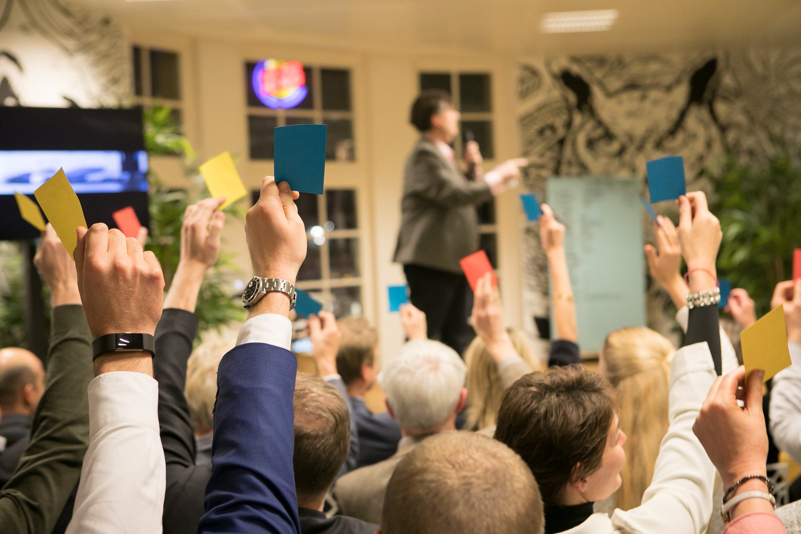 Genoten steken gekleurde stemkaarten omhoog